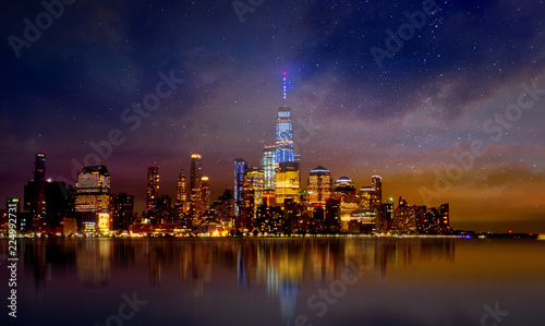  Manhattan skyline with reflections at night, New York City.