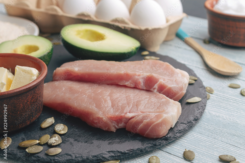 Concept of ketogenic diet. Dietary food on light table Concept of ketogenic diet. Dietary food on light table