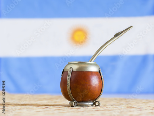 Photography mate, mate grass (yerba mate) with flag of Argentina  in the background