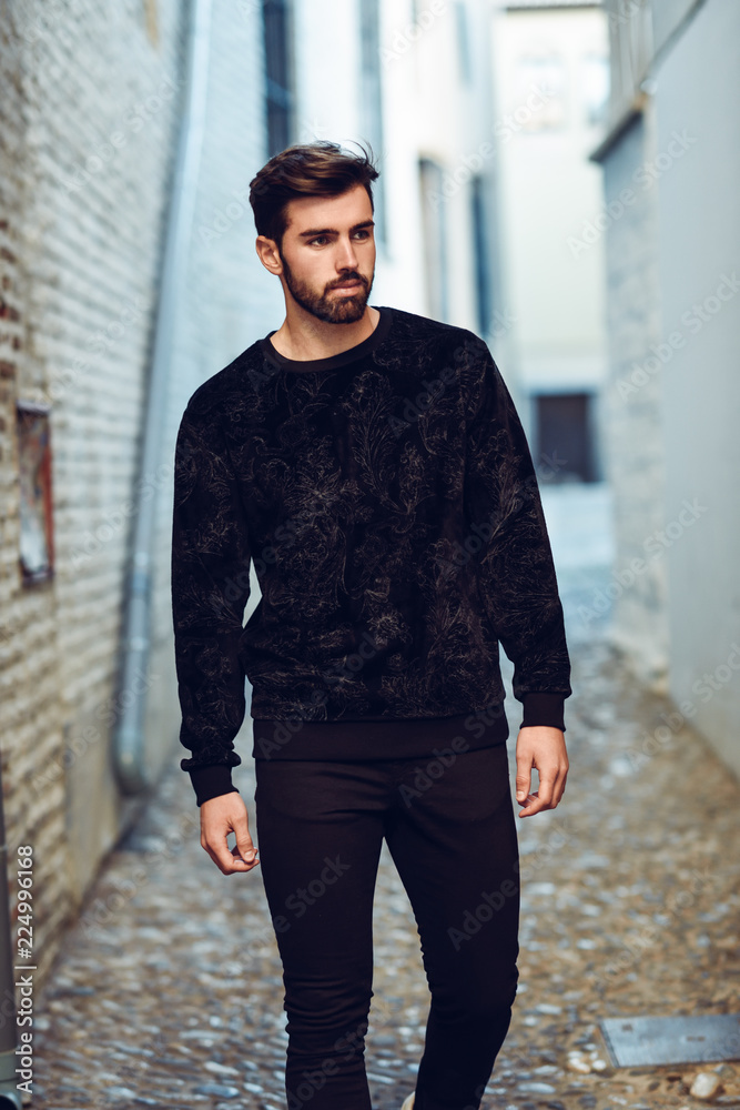 Young bearded man, model of fashion, in urban background wearing casual clothes. Young bearded man, model of fashion, in urban background wearing casual clothes.