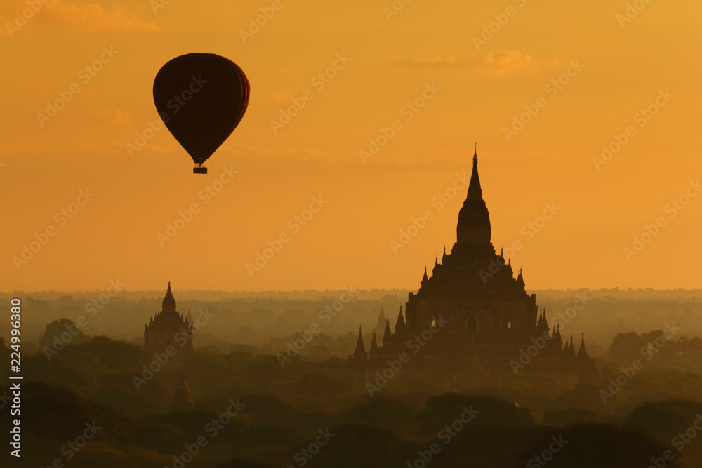  The hot air balloon over plain for tourist and beautiful landscape pagoda ancient with misty morning time of Burma. The landmark tourism culture in Asian.