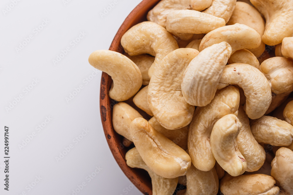 cashew nuts on a white acrylic background cashew nuts on a white acrylic background