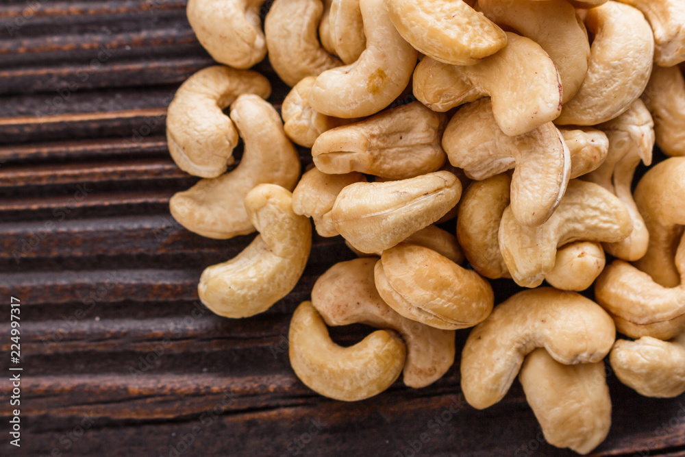 cashew nuts on a rustic wooden background cashew nuts on a rustic wooden background