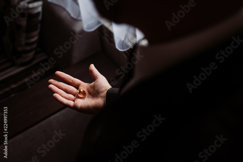 groom holds the wedding rings. Wedding details