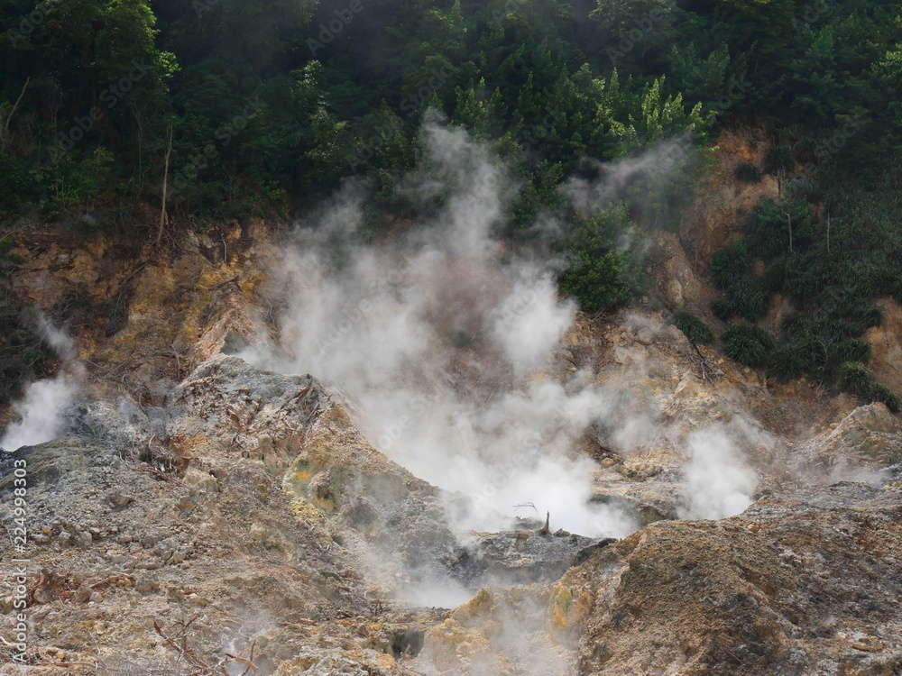 Close up of smoke rising up from the craters at the drive-thru volcano at the Sulphur Springs in St Lucia, Caribbean Islands
