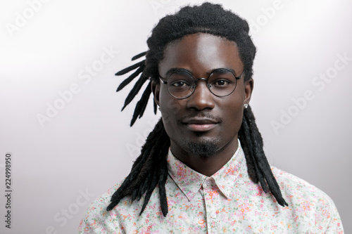 young handsome afro american man with dreadlocks isolated on white background photo