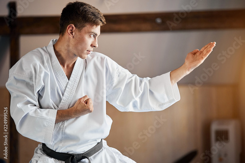 Cuadro en lienzo White Karate Fighter practises fight in martial arts gym