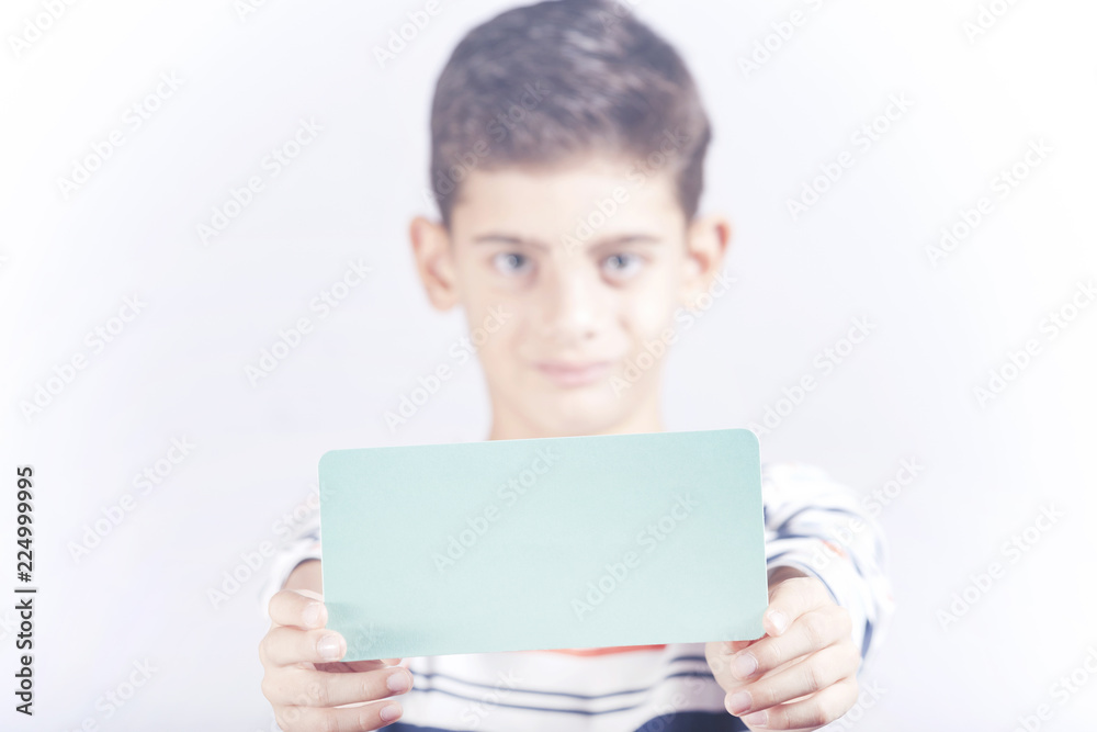 Little boy holding a blank advertising banner with copy space Little boy holding a blank advertising banner with copy space