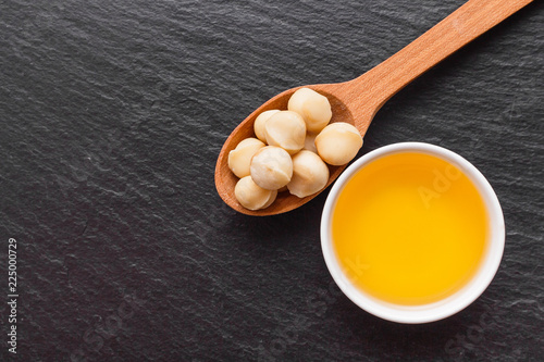 delicious macadamia nuts on a dark stone background