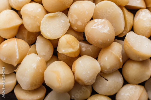 delicious macadamia nuts on a wooden rustic background