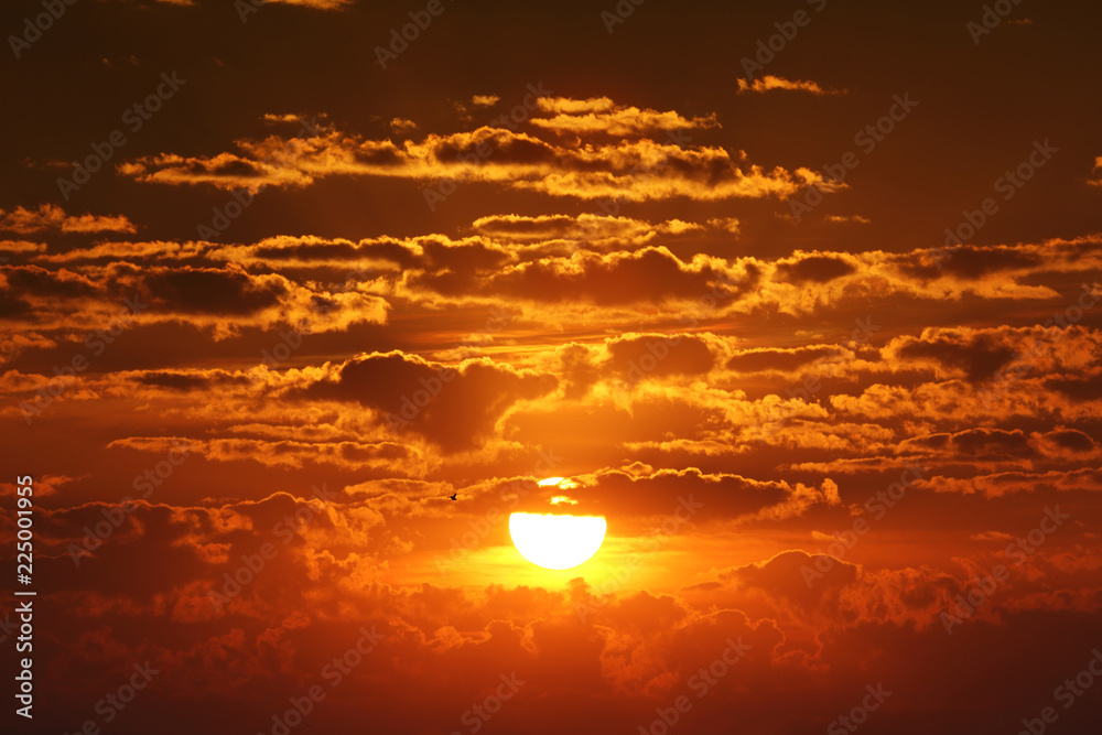 Big sun and clouds in sunrise
