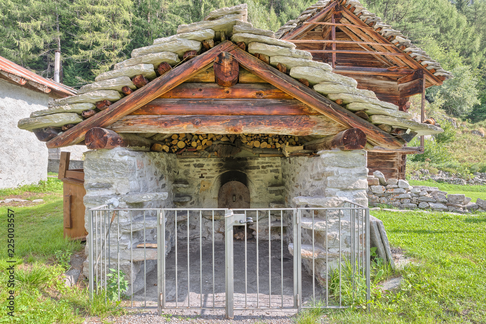 Ancient bread oven with characteristic natural stone roof (piode or lose - beole). Common oven used in the past by the mountain population for baking bread. Macugnaga, Italian alps Ancient bread oven with characteristic natural stone roof (piode or lose - beole). Common oven used in the past by the mountain population for baking bread. Macugnaga, Italian alps