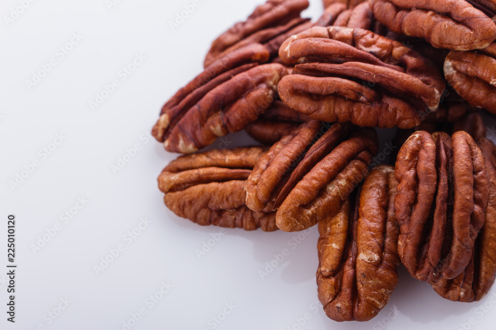 delicious pecan nuts on a white acrylic background delicious pecan nuts on a white acrylic background
