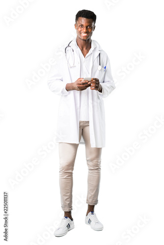 Full body of African american doctor talking to mobile on white background