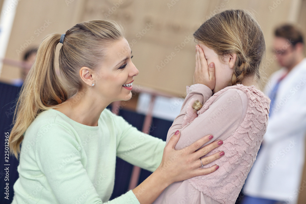 Little girl is crying while with her mother at a doctor on consultation Little girl is crying while with her mother at a doctor on consultation