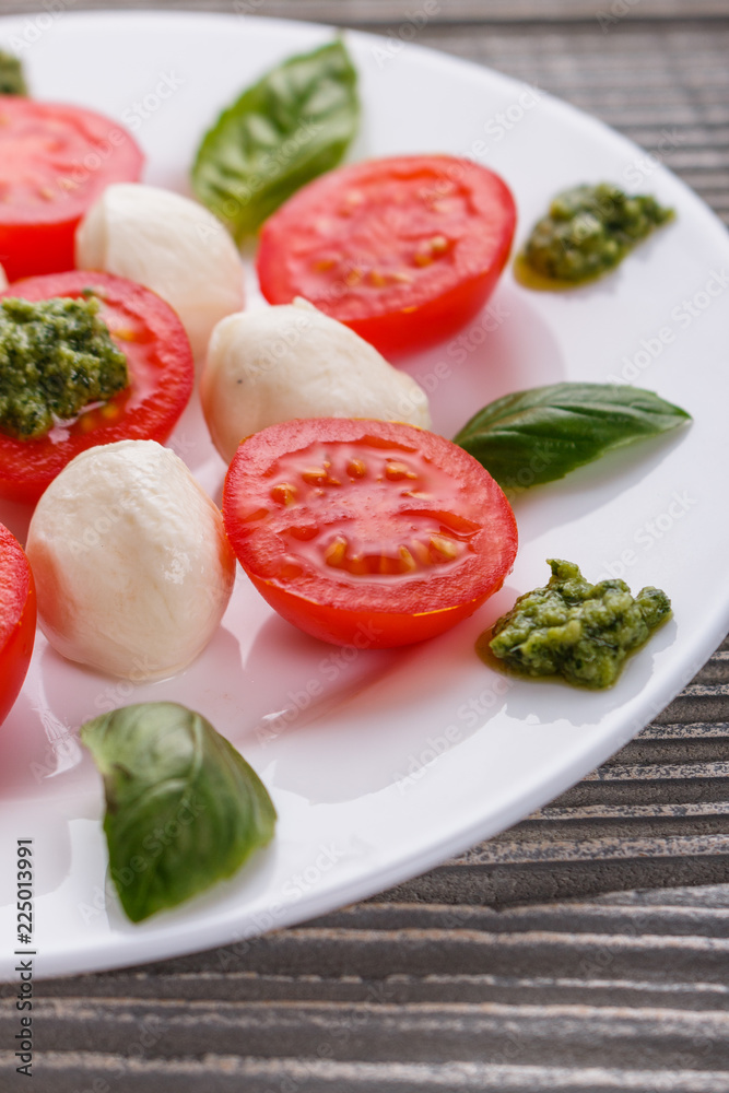 Caprese salad on a wooden rustic background Caprese salad on a wooden rustic background