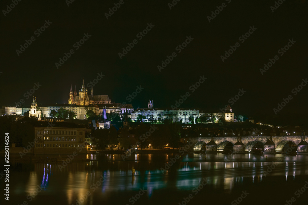 Prague night landscape, a bridge over the river.
