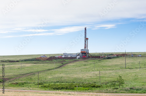 Steppe landscape with drilling rigs and equipment