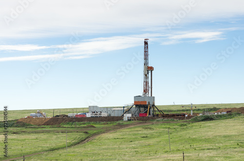 Drilling tower in the steppe. Steppe landscape with drilling rigs and equipment photo