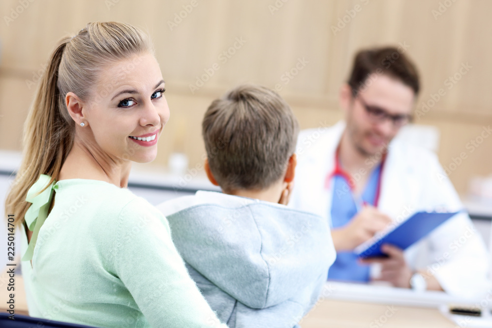 Little boy with mother in clinic having a checkup with pediatrician Little boy with mother in clinic having a checkup with pediatrician