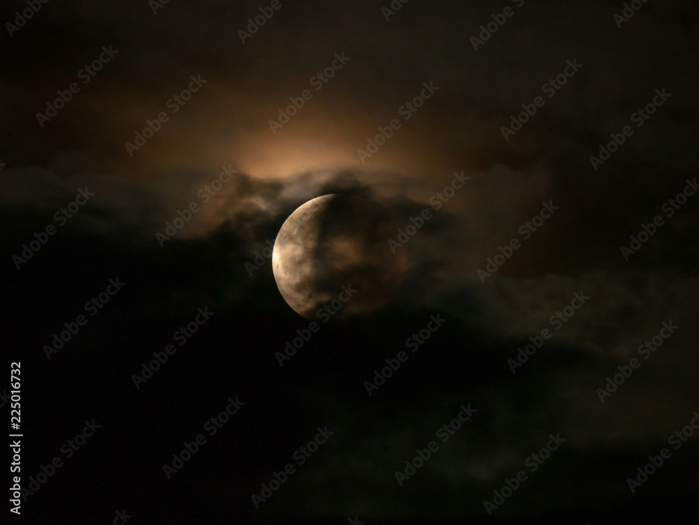 Fototapeta premium Total eclipse of the moon. Lunar eclipse 27. July 2018. Moon eclipse 2018. Red moon on the sky.