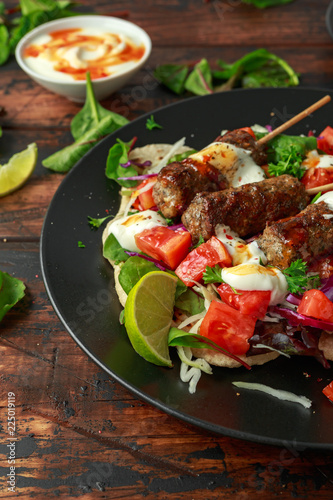 Lamb mint kebabs with flatbread, mix of vegetables, lime and greek yoghurt chilli sauce
