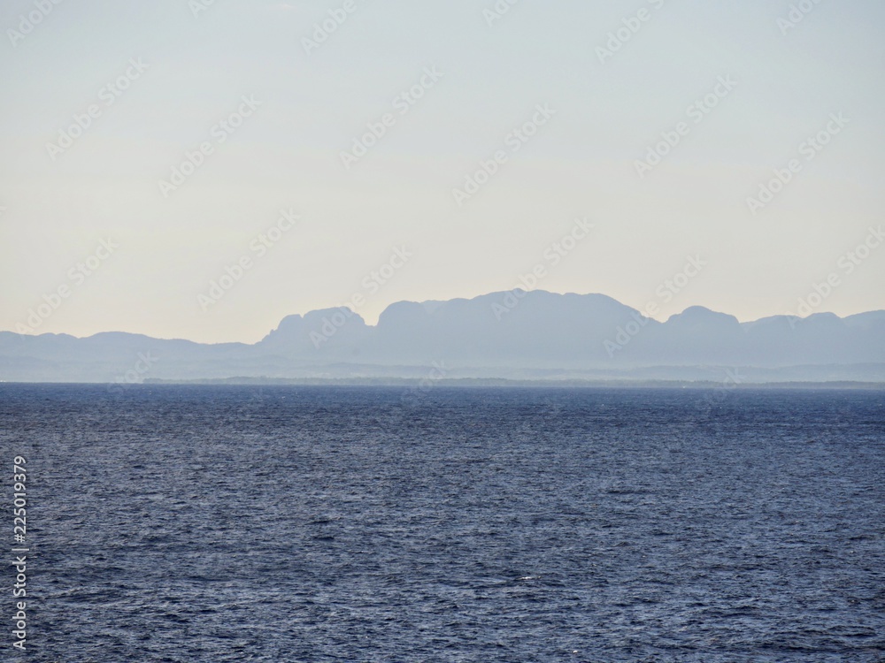 Faint outline of Cuba late in the afternoon seen from the Carribean sea Faint outline of Cuba late in the afternoon seen from the Carribean sea