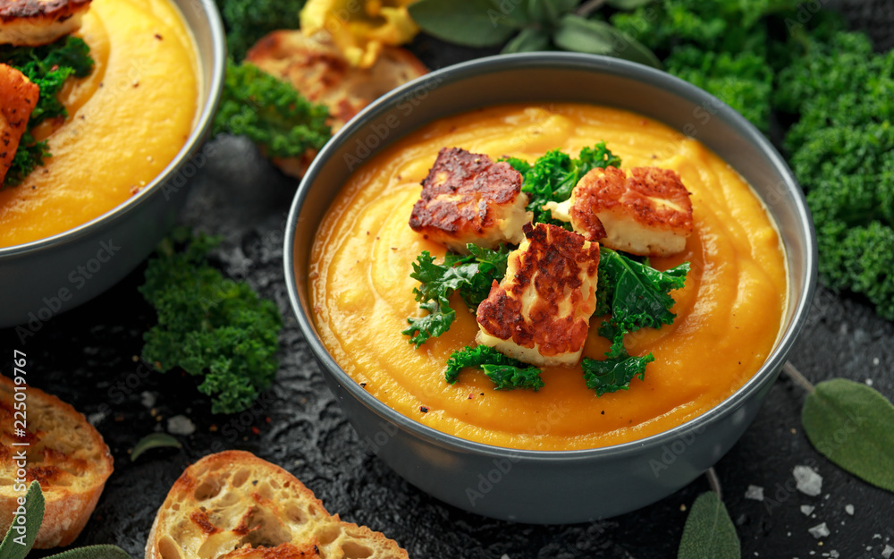 Baked butternut squash and carrot cream soup with steamed kale and fried halluomi