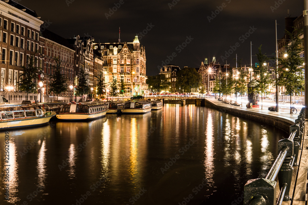 Night city view of Amsterdam channel and typical dutch houses, Holland, Netherlands.