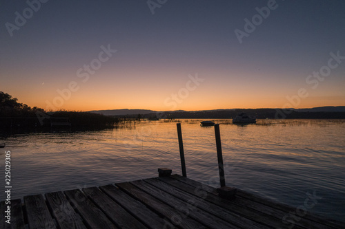 Sunset in Switzerland, view of the Lake Murten, moon rising and sun setting