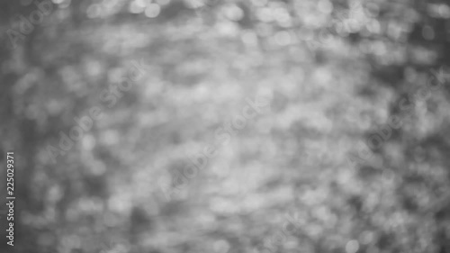 beautiful bokeh of dancing sun reflection on water from the ocean wave at sunset time, abstract background, black and white, monochrome, high definition, Full HD, 1920x1080