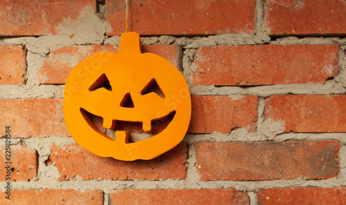 Halloween pumpkin close up on the brick wall background