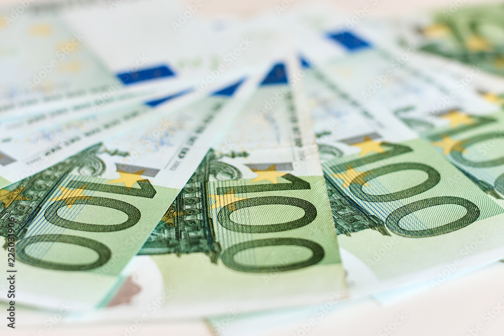 Money. One hundred Euro banknotes. Selective focus
