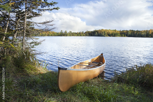 Canoe on the shore of a northern Minnesota lake during autumn
