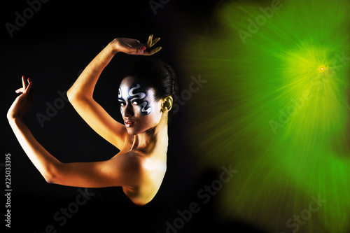 Black african woman on the black background with light © Nikita Vasilchenko