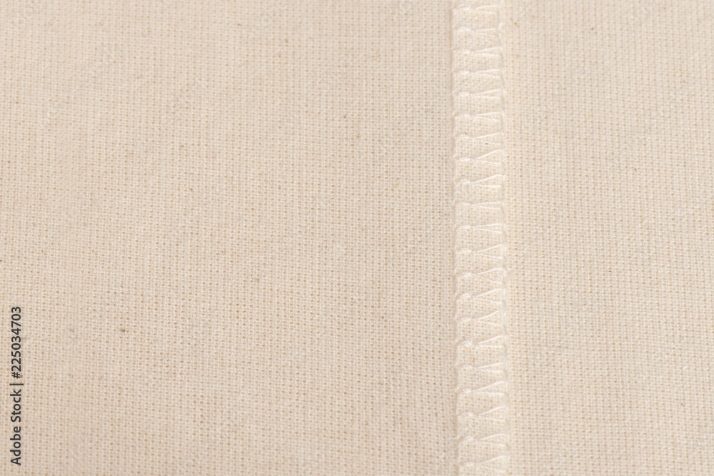Fototapeta premium inner sewing seam on white linen cloth, as background