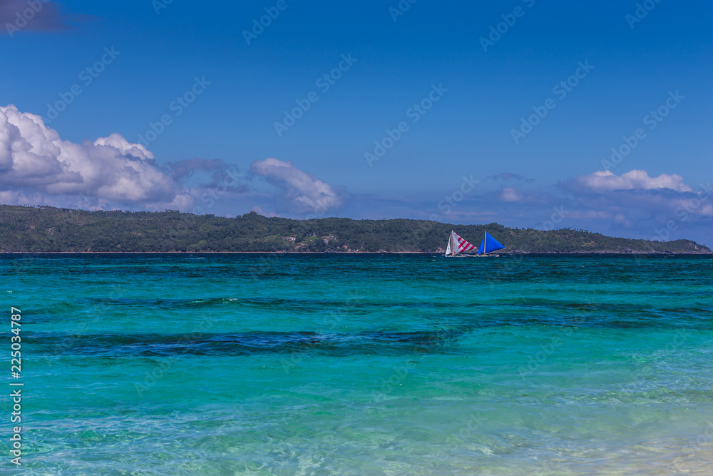 Two double outrigger sailboats on the sea Two double outrigger sailboats on the sea