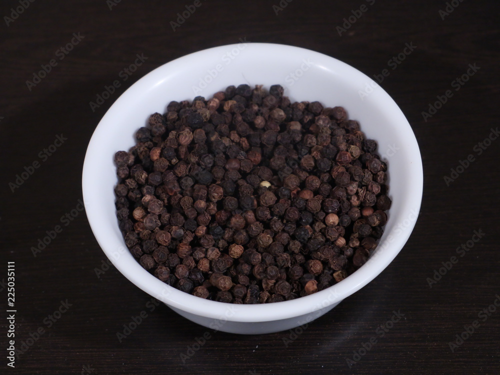 A pile of black pepper isolated on white background,Close up of black peppercorns or kali mari on wooden surface with its extracted herbal beneficial oil, Black Pepper, Kali Mirch, A pile of black pepper isolated on white background,Close up of black peppercorns or kali mari on wooden surface with its extracted herbal beneficial oil, Black Pepper, Kali Mirch,