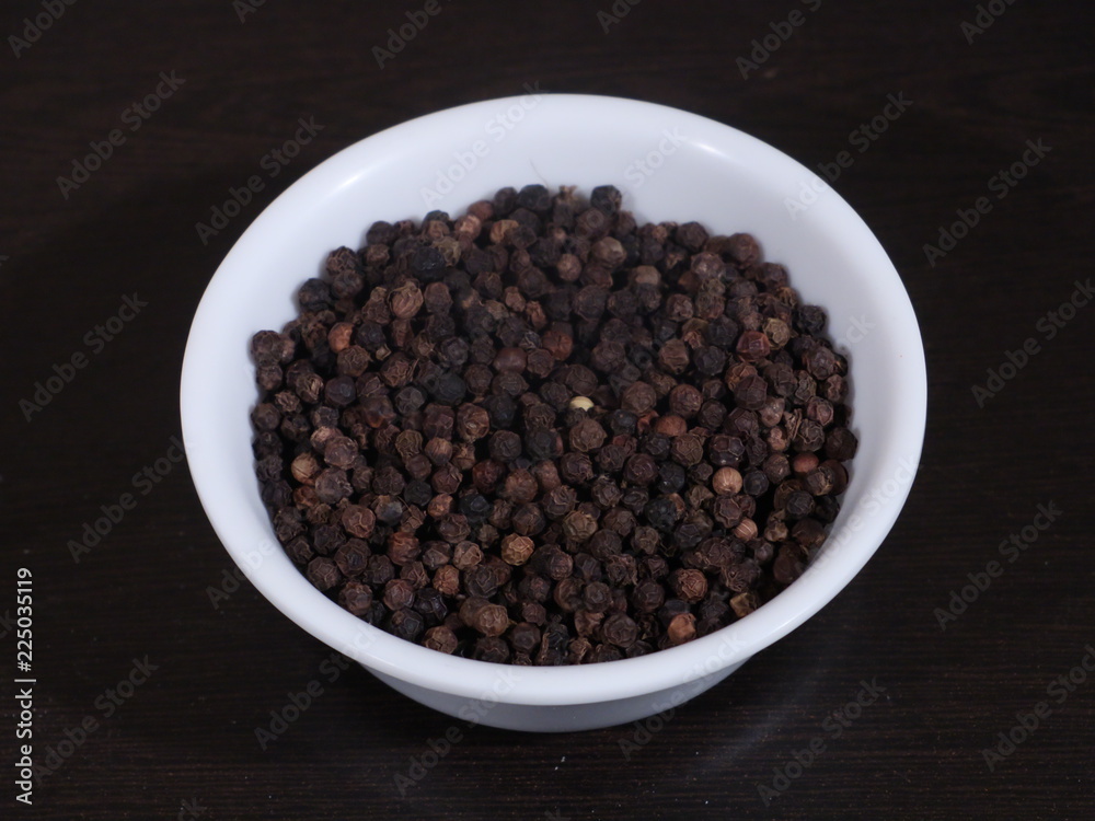 A pile of black pepper isolated on white background,Close up of black peppercorns or kali mari on wooden surface with its extracted herbal beneficial oil, Black Pepper, Kali Mirch, A pile of black pepper isolated on white background,Close up of black peppercorns or kali mari on wooden surface with its extracted herbal beneficial oil, Black Pepper, Kali Mirch,