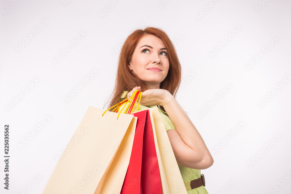 Consumer, sale and people concept - Style redhead woman holding shopping bags Consumer, sale and people concept - Style redhead woman holding shopping bags