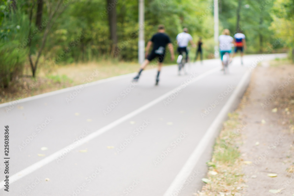 People rollerblading and Biking. Out of focus People rollerblading and Biking. Out of focus