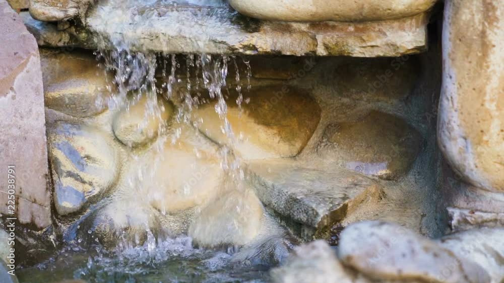 Natural spring drops fall in slow motion. Water flows dribbles and fall in drops Natural spring drops fall in slow motion. Water flows dribbles and fall in drops