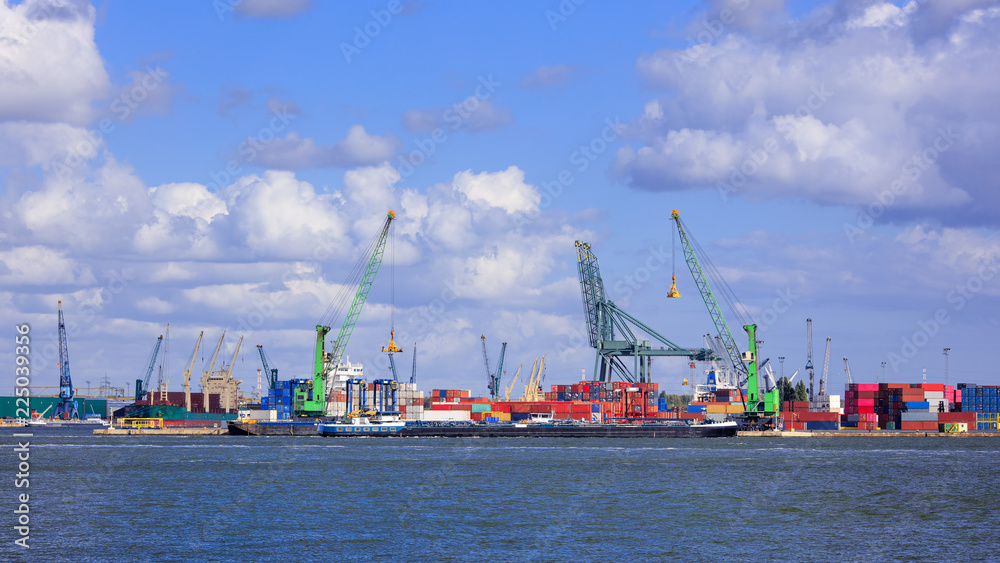 View on container terminal with massive cranes and stacked containers, Port of Antwerp, Belgium
