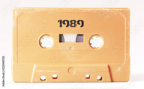 A vintage cassette tape from the 1980s era (obsolete music technology) labeled 1989 (my addition, not in the original image). Color: cream, sand. White background.
 photo