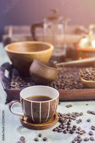 Coffee beans in a wooden Bowl on the wooden floor.