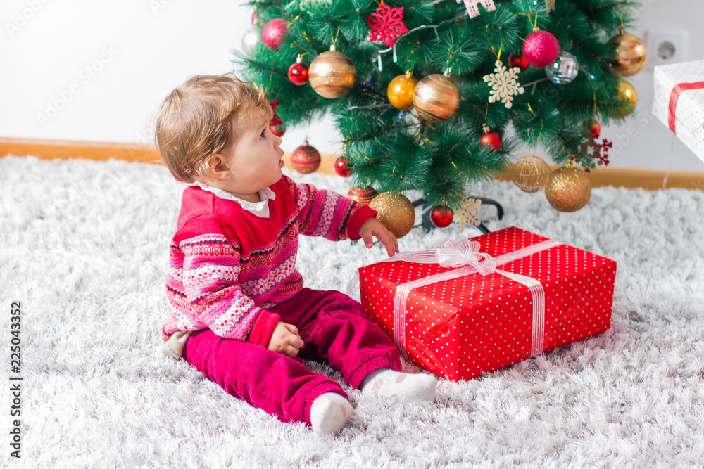 Happy Christmas Child With Gift Box And New Year Tree At Home Happy Christmas Child With Gift Box And New Year Tree At Home