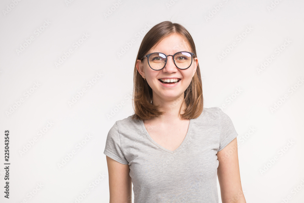 Young beautiful funny woman in glasses over white background with copy space Young beautiful funny woman in glasses over white background with copy space