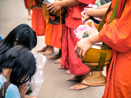 people give some food for monk in Thailand with dramatic tone