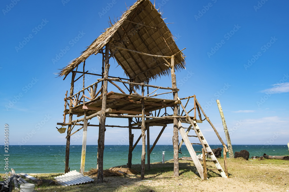 tropical sea view under wooden hut at sunny day. sandy beach and blue sky. soft cloud and island background