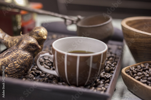 Coffee beans in a wooden Bowl on the wooden floor.